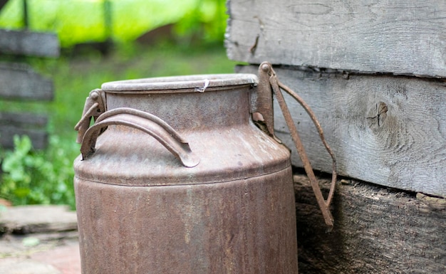 One old rusty metal can in the countryside Container for transporting liquids milk or liquid fuels