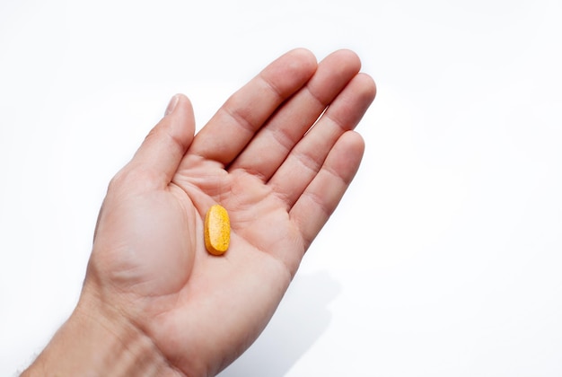 One pills on a males hand