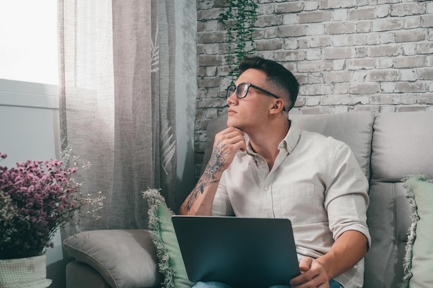 One serious and focused young entrepreneur working hard and analyzing market at home Teenager boy studying and doing homework for school alonexA