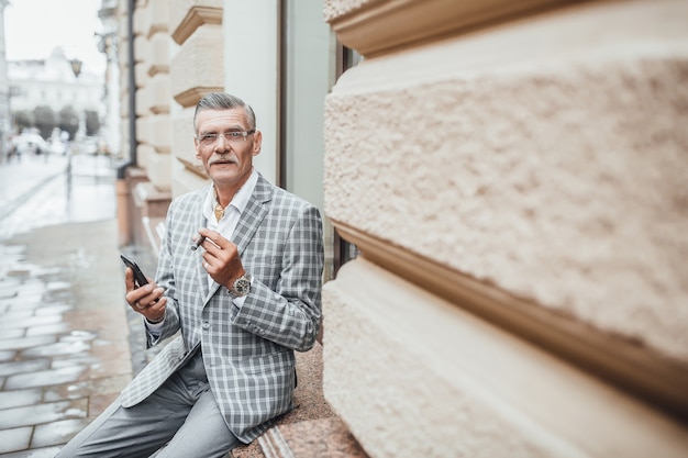 One summer day successful old man with cuban cigarette looking to the camera