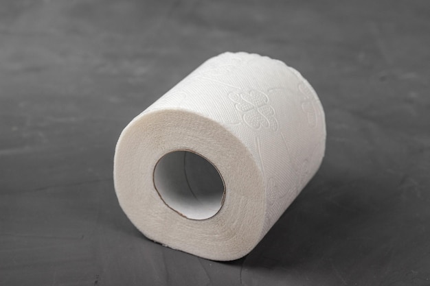 One toilet paper rolls on a gray background