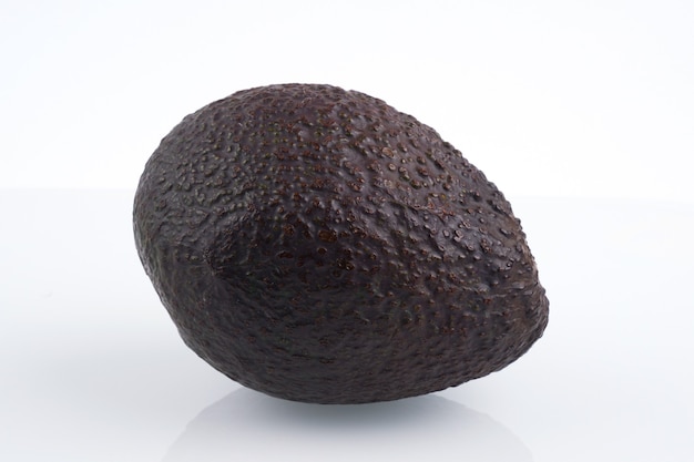 One whole haas avocado isolated on white background, flat lay clipping path