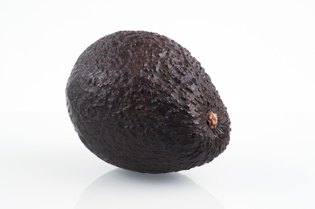 One whole haas avocado isolated on white background, flat lay clipping path