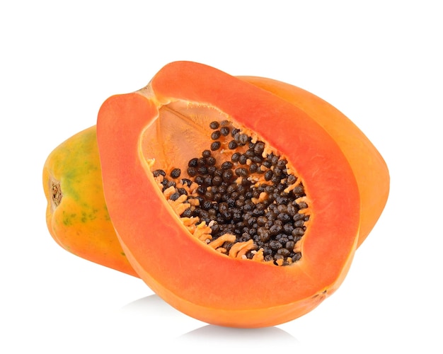 One whole and a half ripe papaya isolated on white background