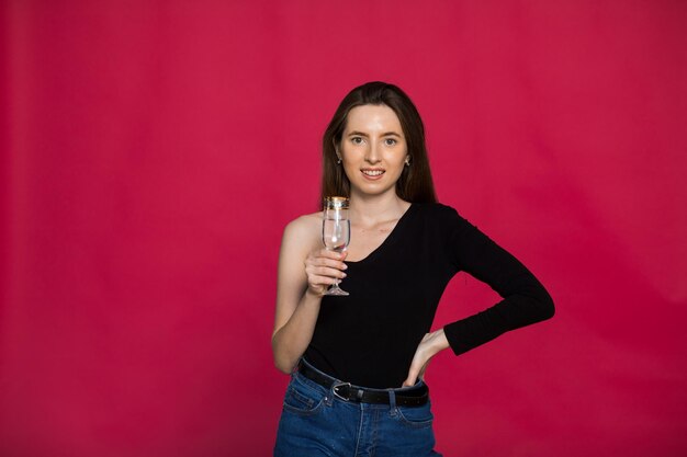 One woman in studio with glass of champagne waiting for Christmas New Year 2023