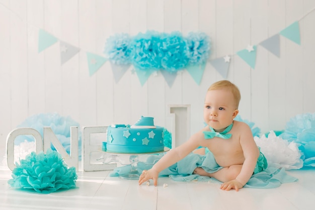 A one-year-old boy tries his first birthday cake. Anniversary Party