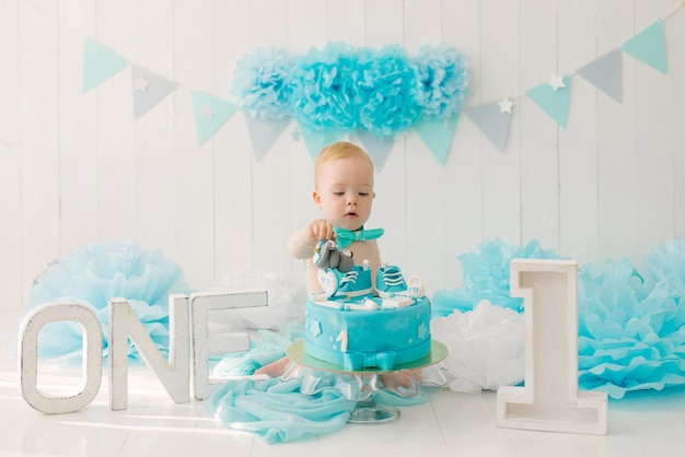 A one-year-old boy tries his first birthday cake