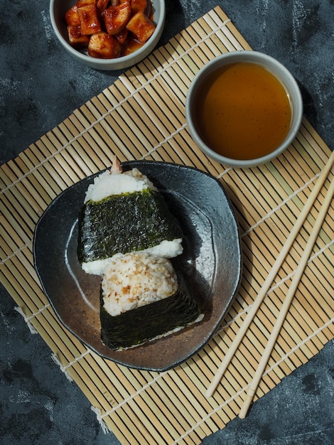 Onigiri Japanese traditional food, steamed rice in triangle shape wrap with seaweed.