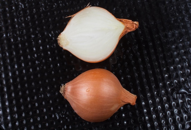 Onion bulb cut in half on background