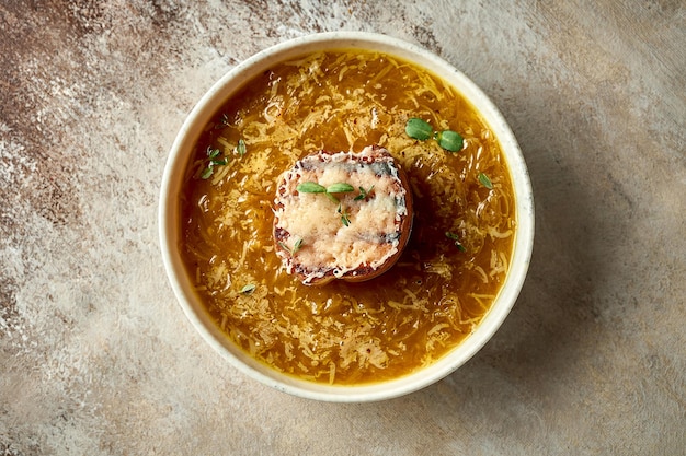 Onion soup with crouton in a bowl A selective trick Closeup French cuisine