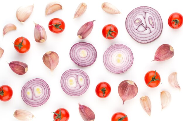 Onion and spices isolated on white background, top view. Wallpaper abstract composition of vegetables.