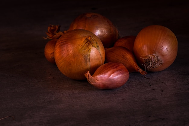 Onions and shallots with a nice light for a kitchen decoration poster