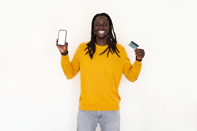 Online Banking Happy Black Man Holding Credit Card And Blank Smartphone