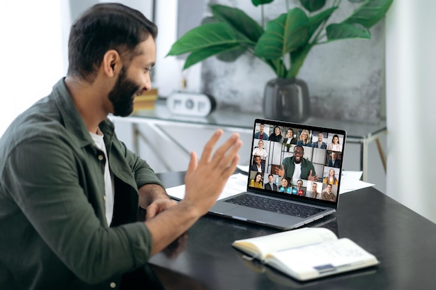 Online conversation Online business meeting brainstorm of employees Indian successful man ceo talking on video conference call with colleagues of different nationalities discussing the project