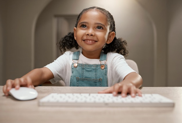 Online education elearning and girl on computer with a smile ready for digital knowledge Web learning kindergarten development and kid on online course training and learning on the internet