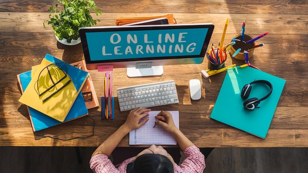 Online learning design concept Top view of student table with computer headphone and stationery