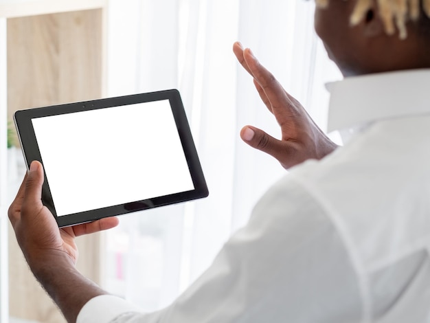 Online meeting black man digital mockup positive unrecognizable guy greeting to tablet computer with