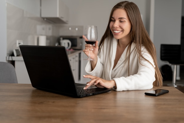 Online party concept. Young beautiful Caucasian-looking woman communicates via video connection via webcam.