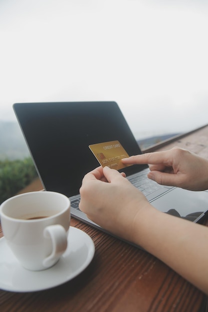 online payment young woman holding credit card and touching on smartphone screen copy space