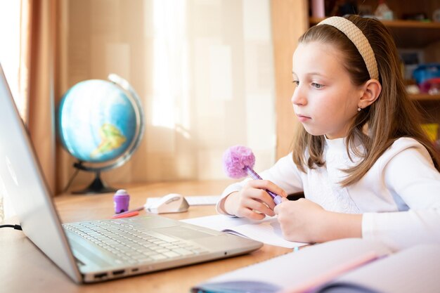 Online remote learning school kid with computer having video conference chat with teacher and class group Teenager studying from home homeschooling distant learning