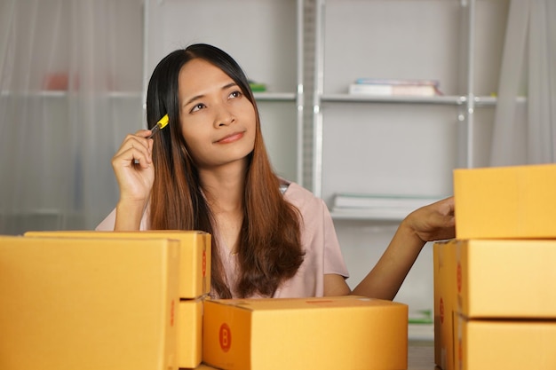 Online retailer checking customer's address on box before sending the goods