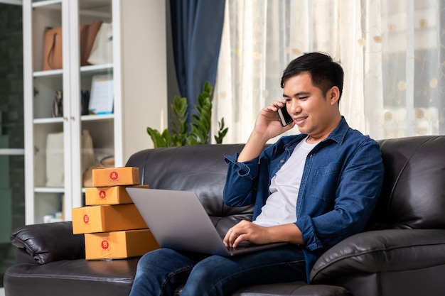 Online sales young start small business in a cardboard box at work.