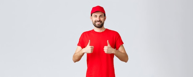 Online shopping delivery during quarantine and takeaway concept cheerful courier in red uniform cap ...