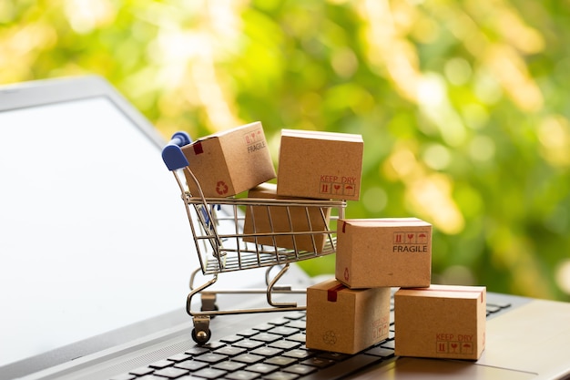 Online shopping, e-commerce concept Boxes in a shopping cart on a laptop keyboard