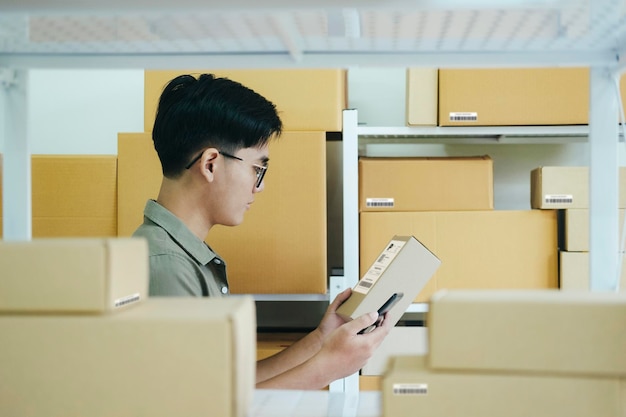 Online store owner checking orders for packaged product