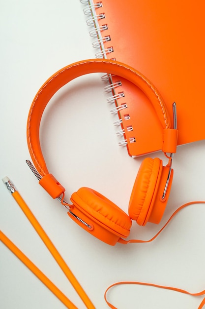 Photo ontop large bright orange headphones on a light background