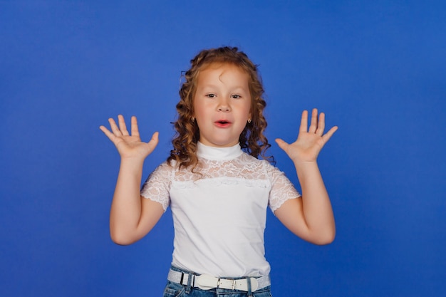 Oops concept or emotion of surprise. Shocked girl raises her hands in delight or wonder