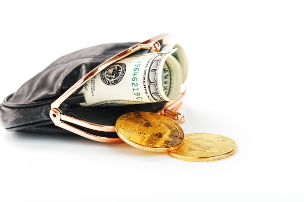 An open black wallet with money dollars and bitcoin coins on a white background