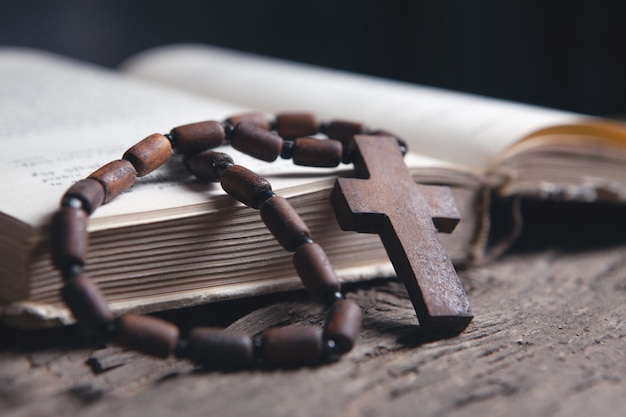 Open book and cross on the table