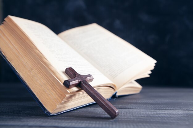 Open book and cross on the table