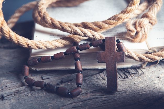 Open book and cross on the table