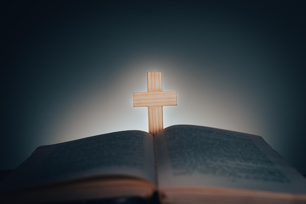 Open book and cross on the table