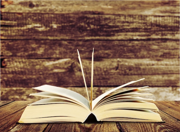 Open book on old wooden table