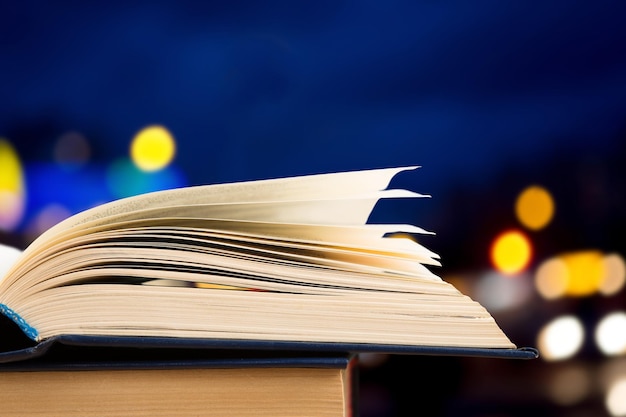 Open book on wood planks over abstract light background