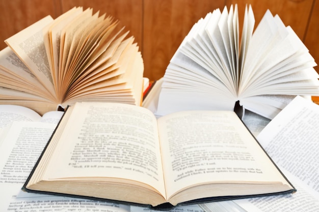 Open books on wooden table