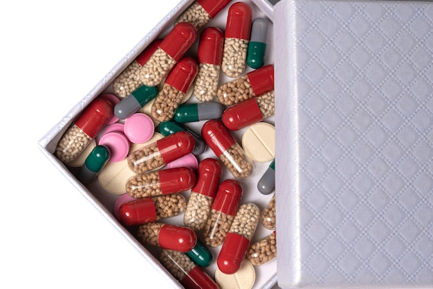 Open box with multicolored tablets capsules and pills Medicines