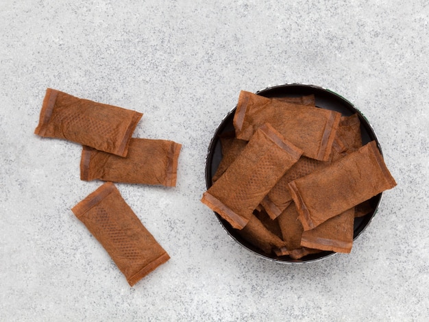 Open can of smokeless tobacco on grey stone background Top view