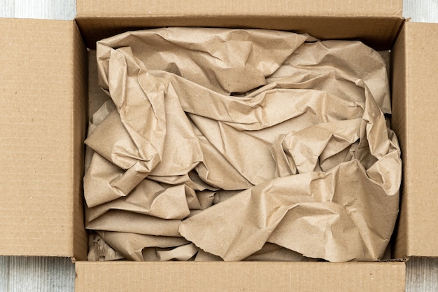 Open cardboard box full of wrapping paper close up