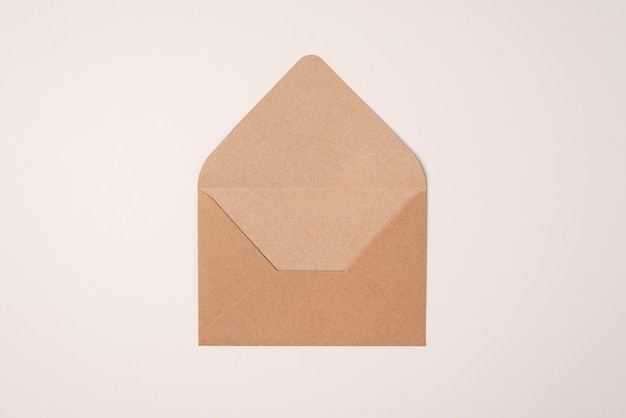 Open craft envelopes on light background of a milky color