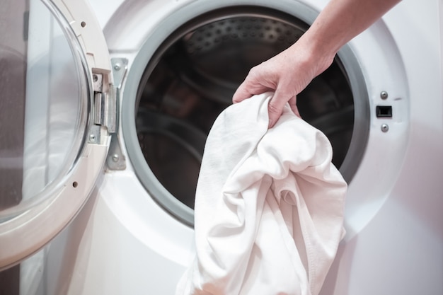 Open door of the washing machine with linen