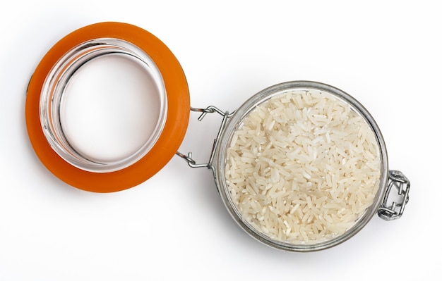 Open jar with raw and dry white rice