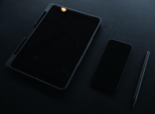 Open laptop with digital tablet and white smartphone All with isolated screen on old wooden desk