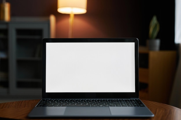 Open laptop with white screen mock up in dark