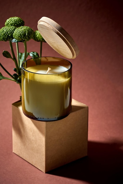 The open lid levitates above the jar with the candle Creative mockup Minimalist composition