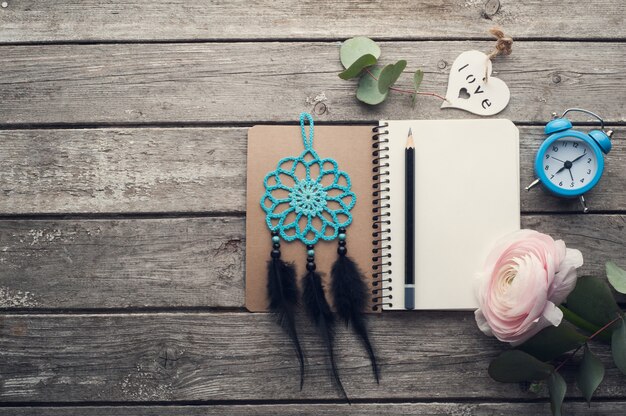 Photo open notebook, dream catcher, alarm clock