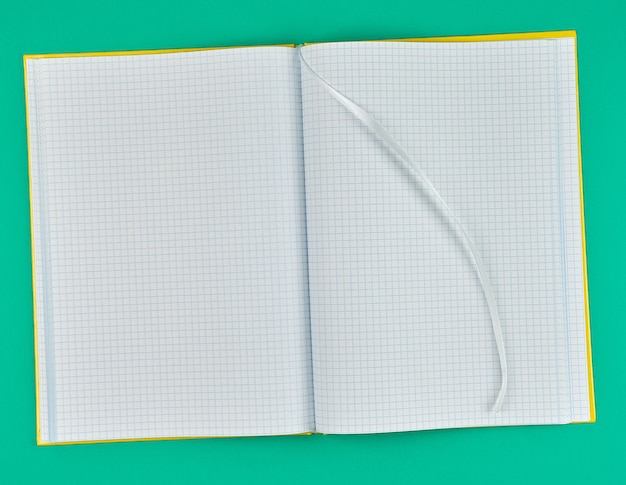 Open notebook in line on a green background